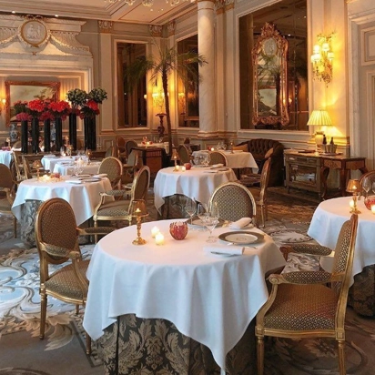 Neatly folded staff uniforms and crisp table linens returned fresh after a professional laundry cycle